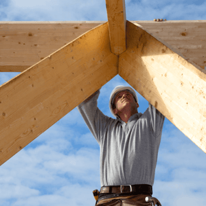 how-to-choose-your-custom-home-builder-carpenter-working-on-roof-image.png