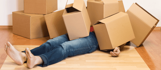 You've Moved Into Your New Home – Now What? Man under Boxes image